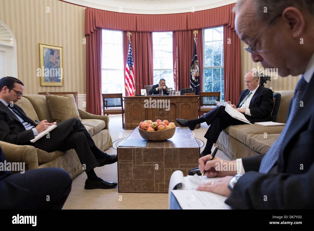 Advisors take notes as United States President Barack Obama has a foreign leader phone call in the Oval Office, March 14, 2013. Seated, from left, are: Evan Medeiros, Director for China, Taiwan, and Mongolia Affairs; National Security Advisor Tom Donilon; and Danny Russel, Senior Director for Asian Affairs..Mandatory Credit: Pete Souza - White House via CNP Stock Photo