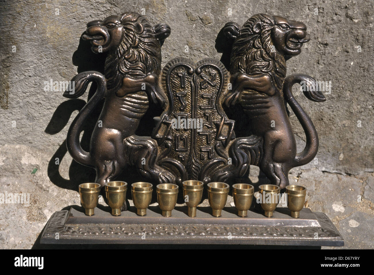 An old decorative bronze menorah lamp, which is a traditional nine-branched candelabrum for use during the Jewish holiday of Hanukkah, the festival of lights Stock Photo