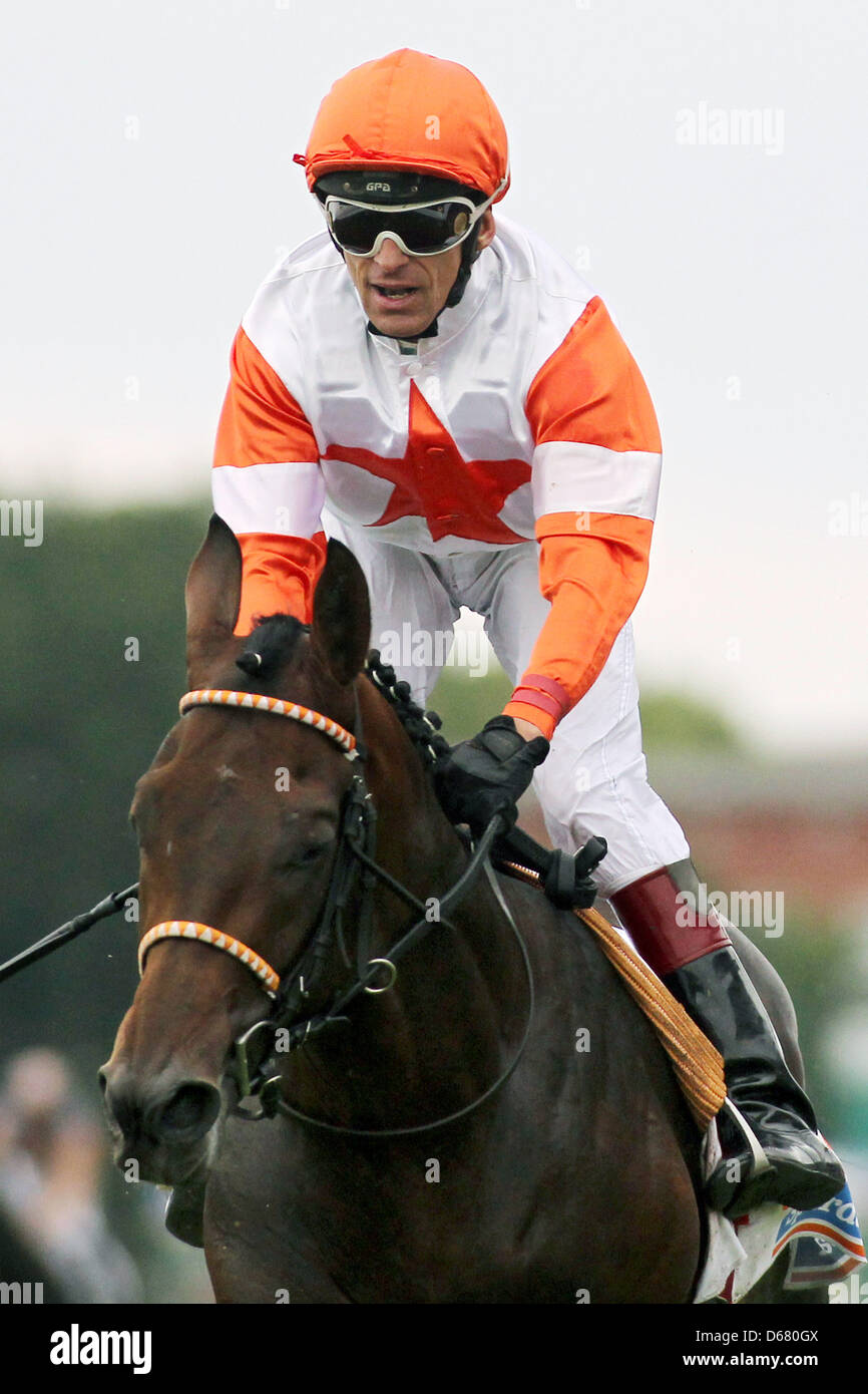 Jockey Terence Hellier on his horse 'Pastorius' crosses the finish line