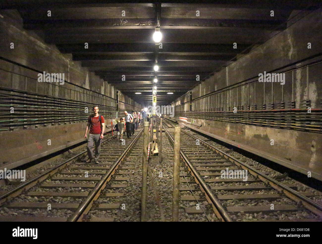 Visitors walk through the 500-meter-long tunnel between the U-Bahn stations Friedrichstrasse and Franzoesische Strasse in Berlin, Germany, 1 July 2012. At their Tunnel Day, the Berlin Transport Company (BVG) invited visitors to  take '500 Steps For the New U5', exploring the paths between the train stations above ground and underground. Photo: Stephanie Pilick Stock Photo