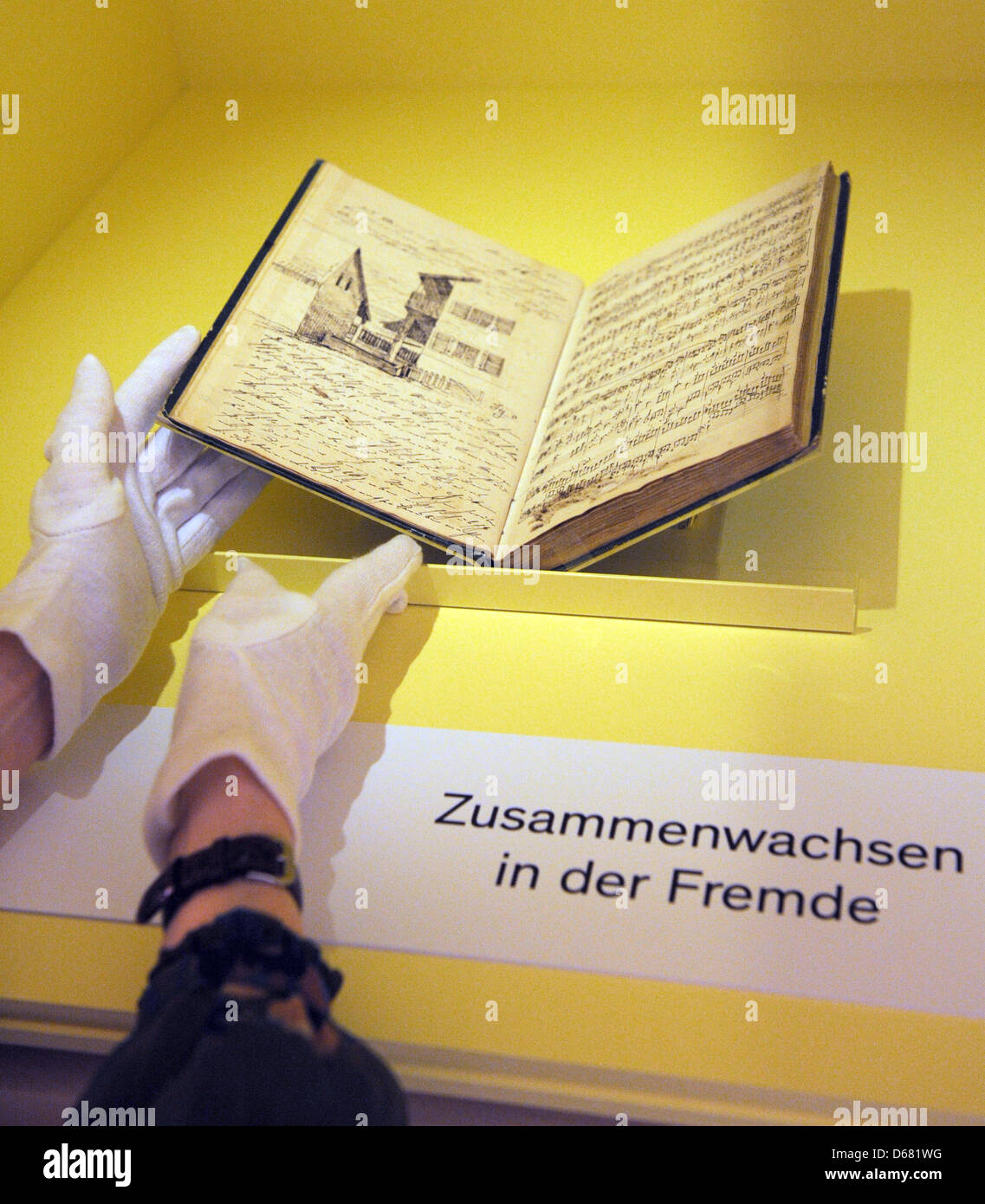 An employee of the Augustiner Museum places the diary of Felix Mendelssohn Bartholdy (1809-1847) in a showcase at the museum in Freiburg, Germany, 02 July 2012. Until 30 September 2012, the composer's diary, written with his wife Cécile, will be on loan from the Bodleian Library at Oxford. Photo: PATRICK SEEGER Stock Photo