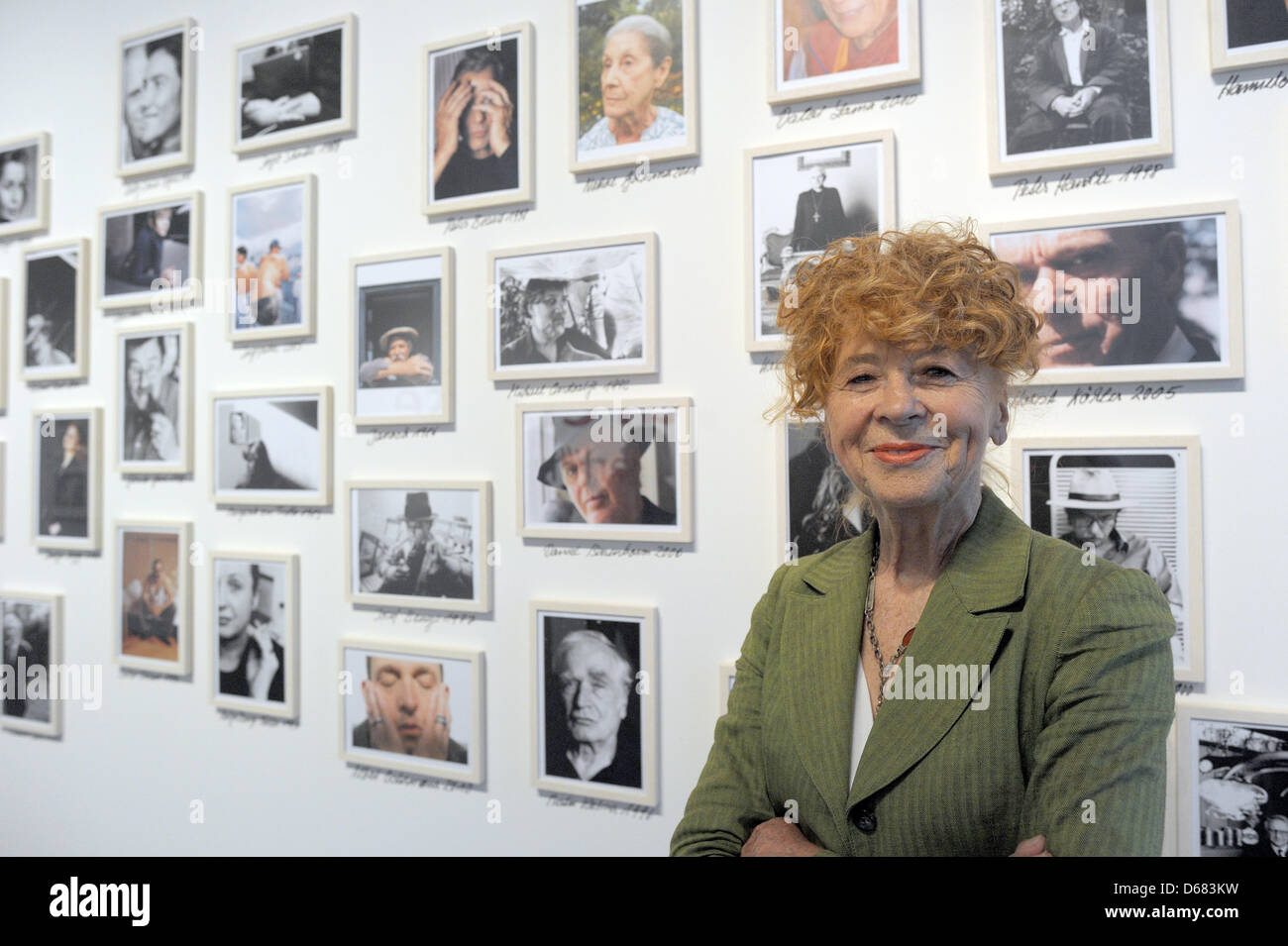 Photographer Herlinde Koelbl poses in front photographs at her exhibition titled 'Looking for Traces - Photographies of Herlinde Koelbl' at Haus der Geschichte in Bonn, Germany, 04 July 2012. 400 photographs by Koelbl are on display. Photo: FEDERICO GAMBARINI Stock Photo