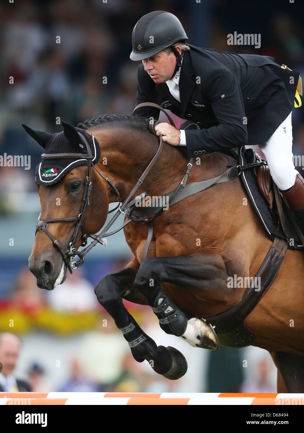 British show jumper Nick Skelton jumps over a hurdle on his horse Big Star at CHIO in Aachen, Germany, 04 July 2012. Skelton won the Prize of Europe. Photo: ROLF VENNENBERND Stock Photo