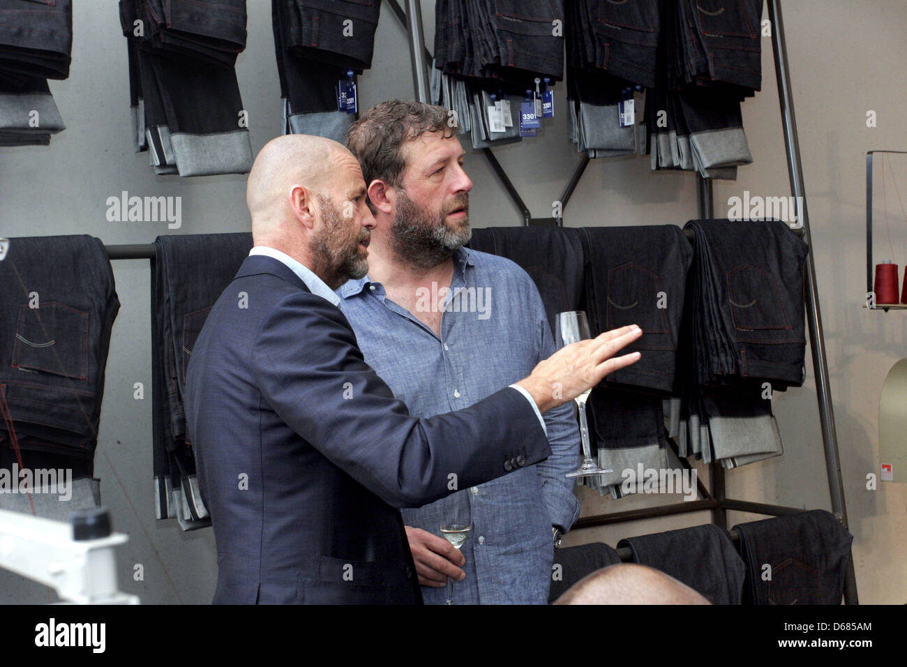 Head of the jeans label G Star, Jos van Tilburg, talks to head B&B, Karl Heinz Mueller (R) at a booth of the label at the fashion fair Bread & Butter
