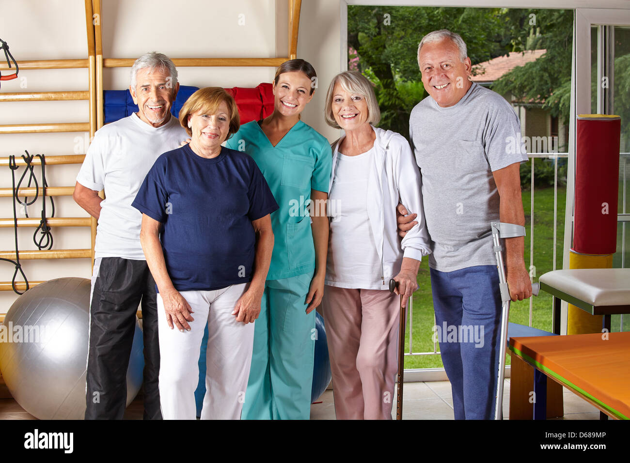 Group of senior people in physiotherapy with physiotherapist Stock Photo