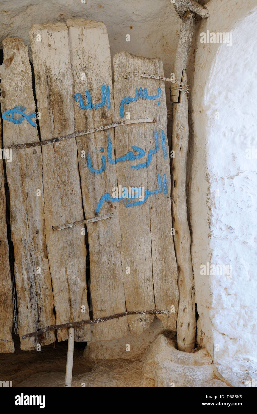 Heavy  old wooden door at the entrance to a Troglodyte  cavehouse Matmata Tunisia Stock Photo