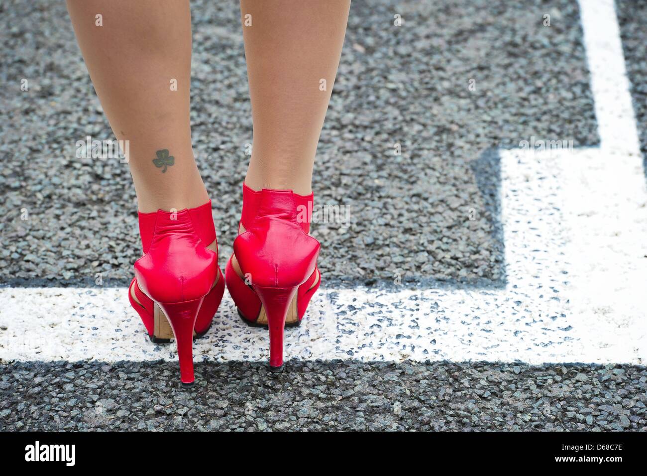 A grid girl with a shamrock tattoo stands in the grid before the start of the Grand Prix of Great Britain at the Silverstone race track in Northamptonshire, Great Britain, 08 July 2012. Photo: David Ebener Stock Photo