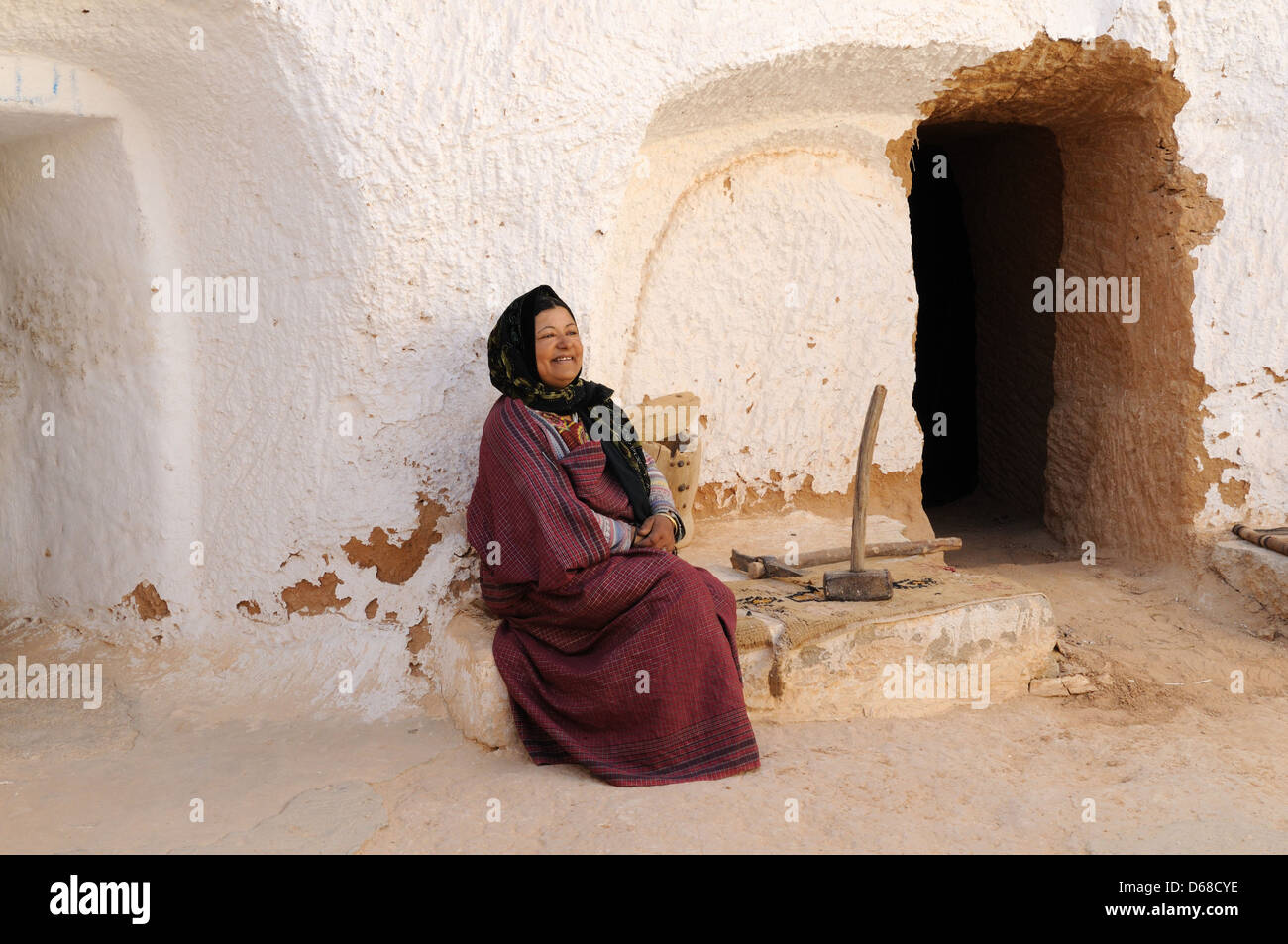 Berber woman sitting in her Troglodyte cave house Matmata Tunisia Stock Photo