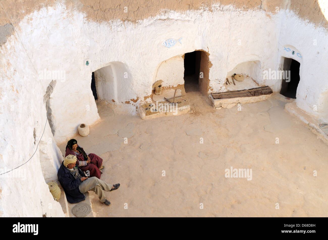 Berber couple sitting in their troglodyte cave house Matmata Tunisia Stock Photo