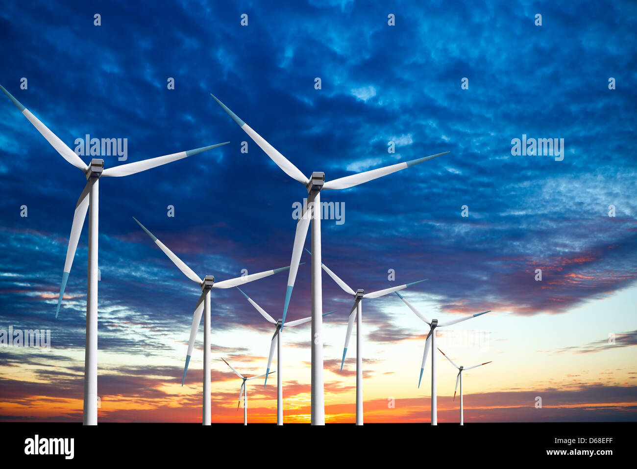 Wind turbines farm at sunset Stock Photo