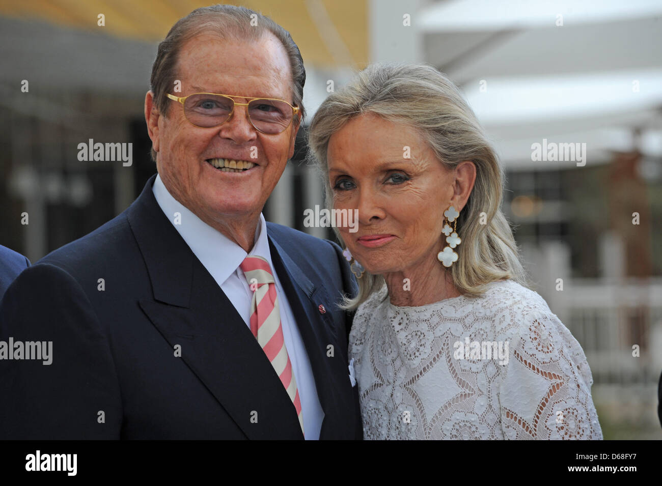British actor Sir Roger Moore and his wife Kristina Tholstrup pose for the photographers in front of the new hotel 'Bell Rock' at theme park Europa Park in Rust, Germany, 12 July 2012. Photo: Patrick Seeger Stock Photo