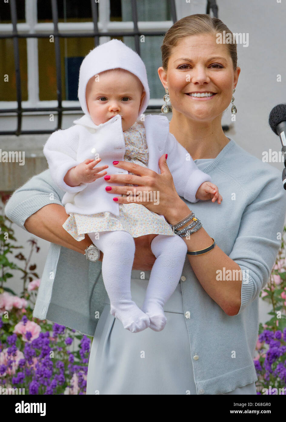 Swedish Crown Princess Victoria holds her daughter Princess Estelle at(02)