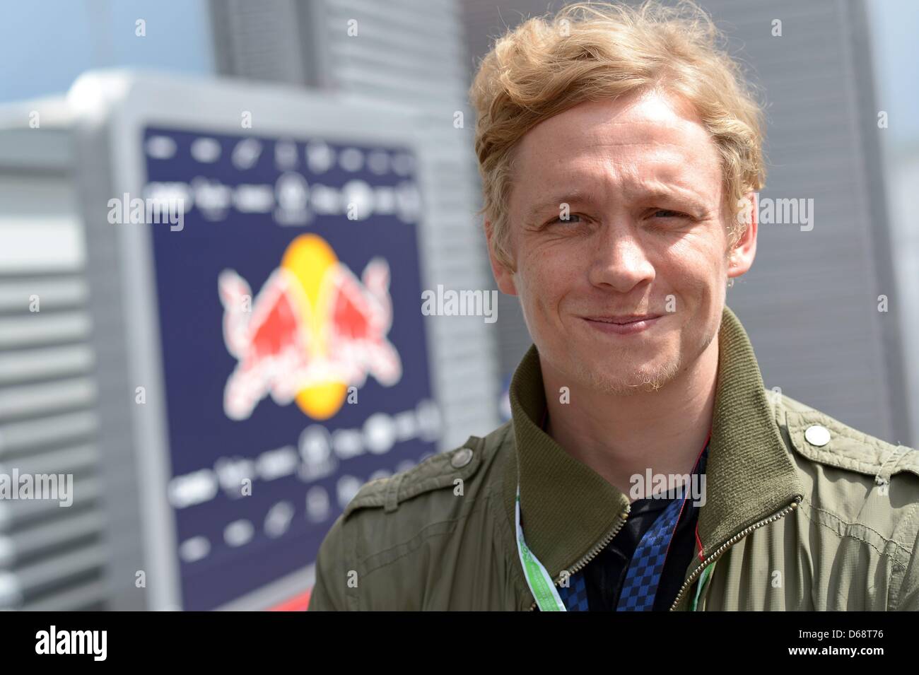 German actor Matthias Schweighoefer smiles in the paddock at the