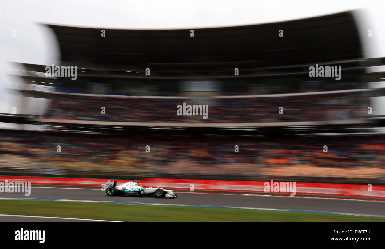 German Formula One driver Michael Schumacher of Mercedes AMG steers his car past Suedkurve during the Qualifying session at the Hockenheimring race track in Hockenheim, Germany, 21 July 2012. The Formula One Grand Prix of Germany will take place on 22 July 2012. Photo: Jens Buettner dpa Stock Photo