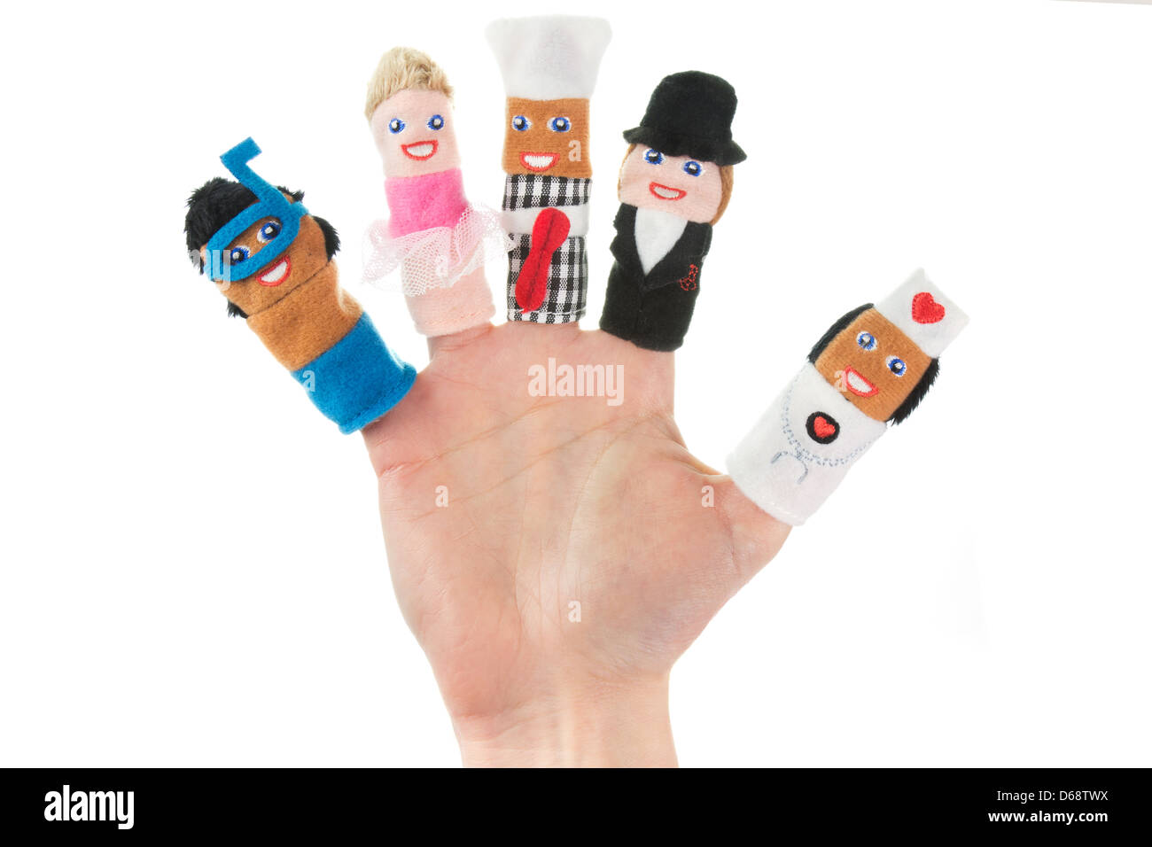Hand holding five finger puppets (scuba diver, ballerina, chef, nanny, nurse) Stock Photo