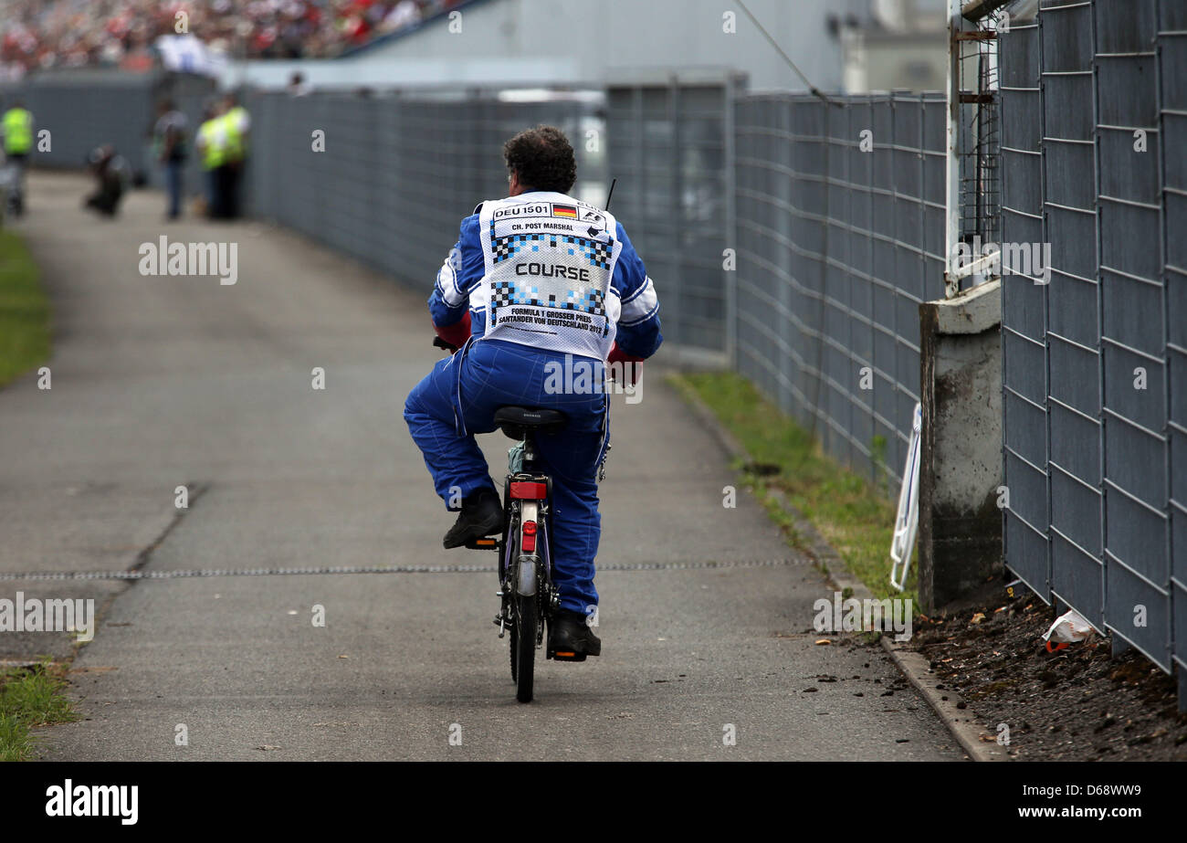 A marshal rides his bike off the track during the Formula One Grand Prix of Germany at the Hockenheimring race track in Hockenheim, Germany, 22 July 2012. Photo: Jens Buettner dpa  +++(c) dpa - Bildfunk+++ Stock Photo