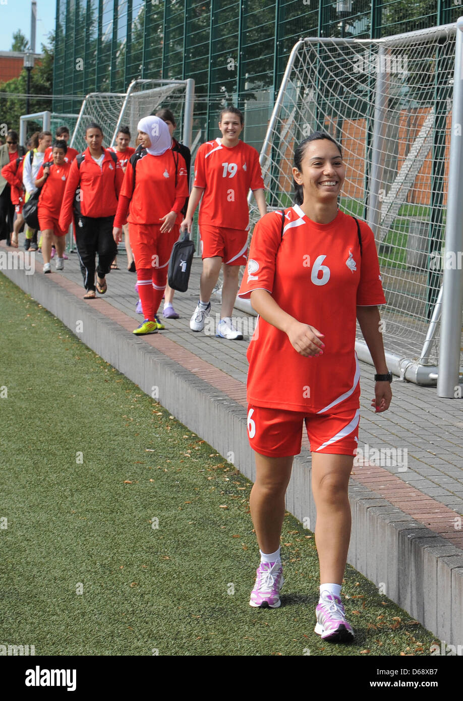 Members of the women's Palastinian national soccer team, amongst them Jackline Jazrawi (R-L), Dina Samara and Nivine Al Kolayb, arrive for a training session in Potsdam, Germany, 23 July 2012. The women's Palastinian national soccer team is currently in a training camp at the FFC Turbine Potsdam. Photo: BERND SETTNIK Stock Photo