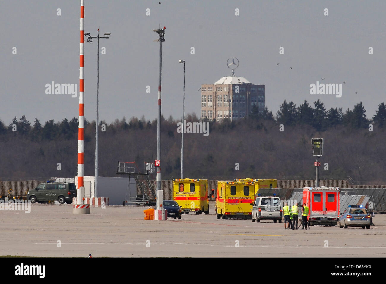 Yellow vehicles from the German Army's emergency medical service are parked on the runway at the airport in Stuttgart, Germany, 15 April 2013. Critically injured victims of the civil war in Syria were transported on a German Army Airbus out of Amman, Jordan, where they were being treated, for further treatment in Germany on the aircraft. Photo: THOMAS NIEDERMUELLER Stock Photo