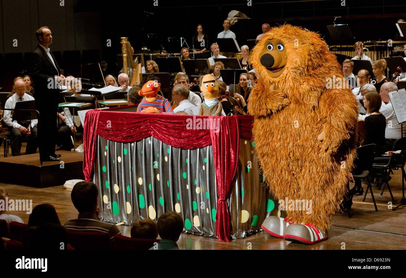 The Sesame Street characters Ernie (L-R), Bert and Samson take part in a concert at the Schleswig-Holstein Music Festival in Kiel, Germany, 26 July 2012. During the concert of the NDR Radio philharmonic orchestra conducted by Rasmus Baumann, the characters Ernie, Bert and Samson heard and commented Rimsky-Korsakov's 'Flight of the Bumblebee', Mancini's 'Pink Panther' and other piec Stock Photo