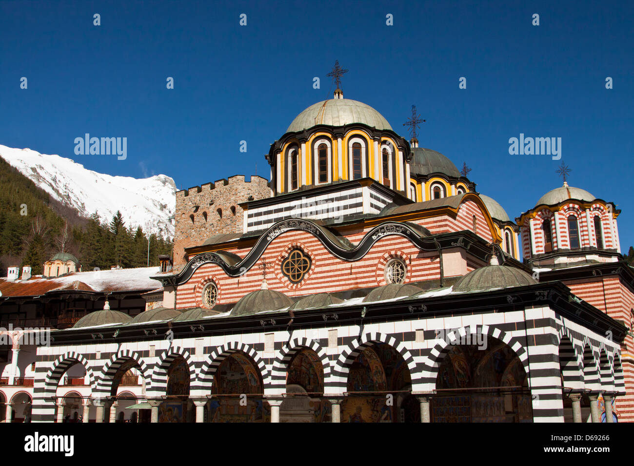 Rila Monastery in southwestern Bulgaria, snow-covered mountains in the background Stock Photo