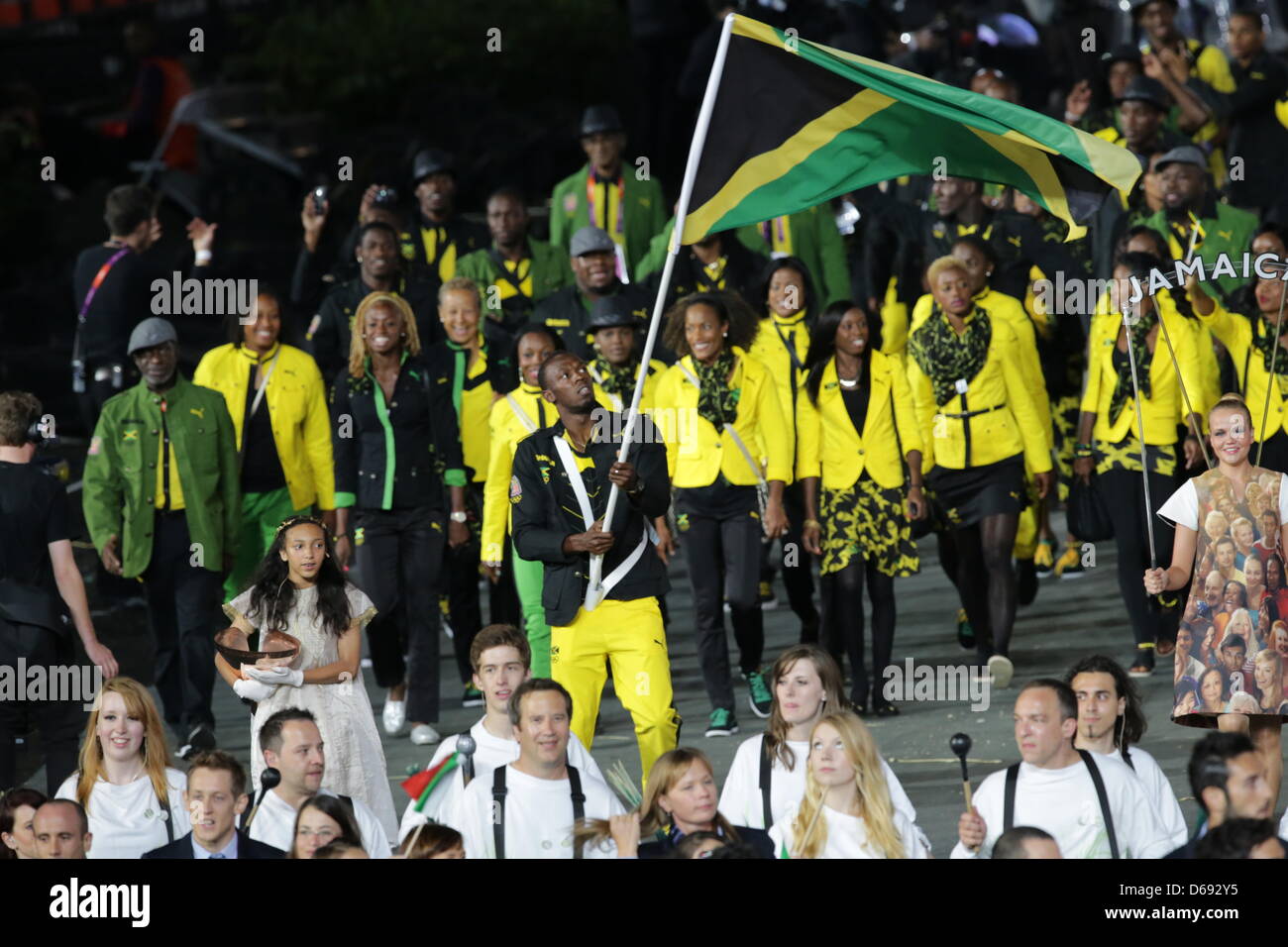 Jamaica's sprinter and flag bearer Usain Bolt leads the team into the