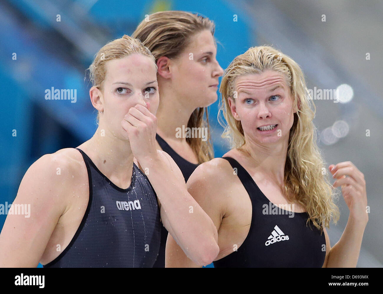Daniela Schreiber, (L-R), Lisa Vitting and Britta Steffen of Germany react  after the Women's 4x100m Freestyle Relay Heat during the Swimming  competition held at the Aquatics Center during the London 2012 Olympic