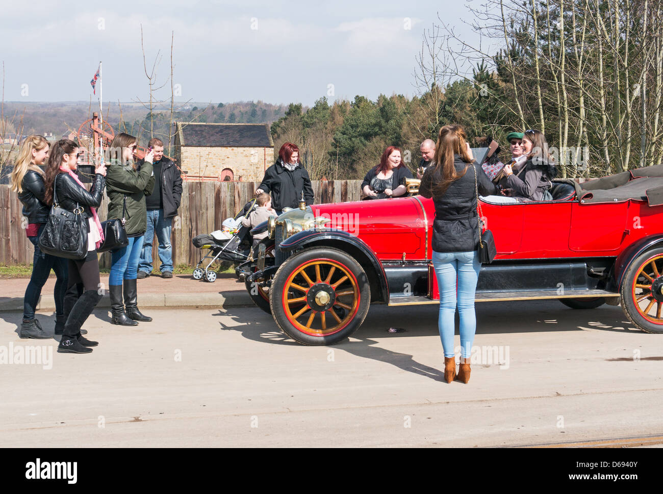 Young woman poses for photos in 1914 Star Torpedo tourer vintage car Beamish Museum north east England UK Stock Photo