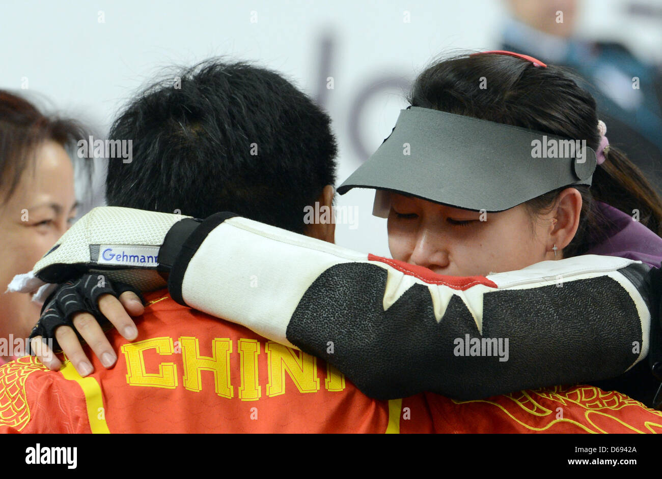 Siling Yi (R) of China celebrates with a teammate after winning the women's 10 meter air rifle final of the shooting competition in The Royal Artillery Barracks at the London 2012 Olympic Games, London, Great Britain, 28. July 2012. Photo: Peter Kneffel dpa  +++(c) dpa - Bildfunk+++ Stock Photo