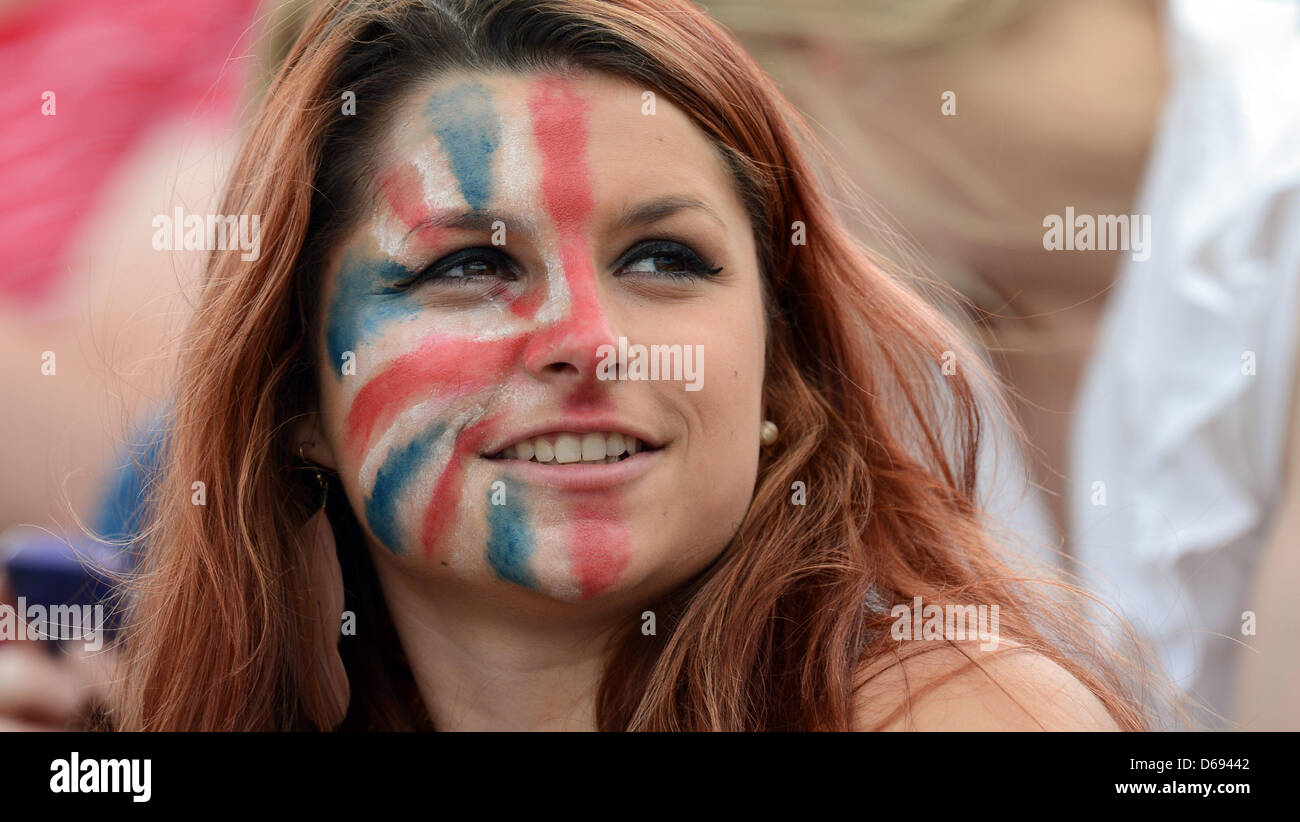 A british eventing fan colored half her face with a Union Jack at the