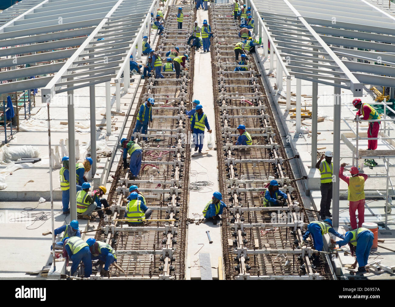 Construction workers laying railway tracks for  new Al Sufouh Tramway in Dubai United Arab Emirates Stock Photo