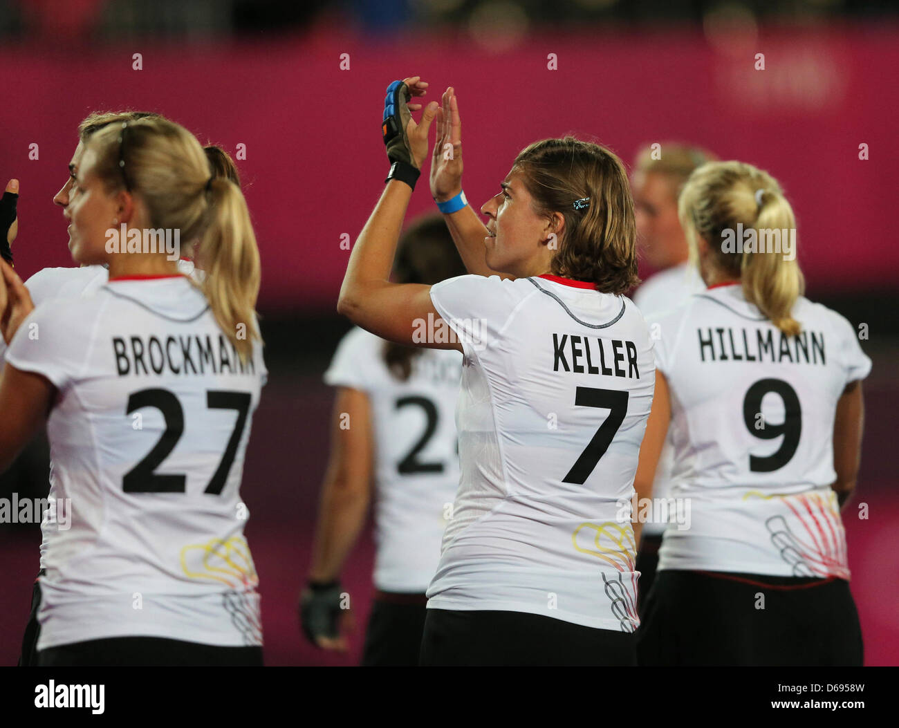 The Germany team (L-R) Anke Brockmann, Natascha Keller and Kristina Hillmann celebrate at the end of the game against the United States during women's field hockey at Olympic Park Riverbank Arena for the London 2012 Olympic Games, London, Britain, 29 July 2012. Photo: Christian Charisius dpa  +++(c) dpa - Bildfunk+++ Stock Photo