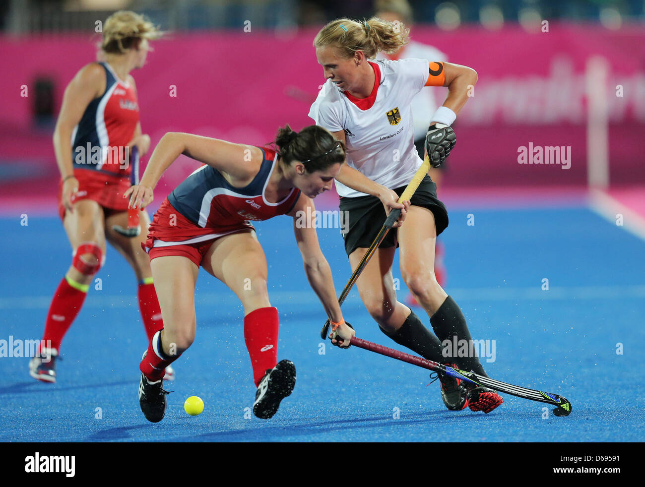 Germany's Fanny Rinne (R) competes with Michelle Vittese of United States during women's field hockey at Olympic Park Riverbank Arena for the London 2012 Olympic Games, London, Britain, 29 July 2012. Photo: Christian Charisius dpa Stock Photo
