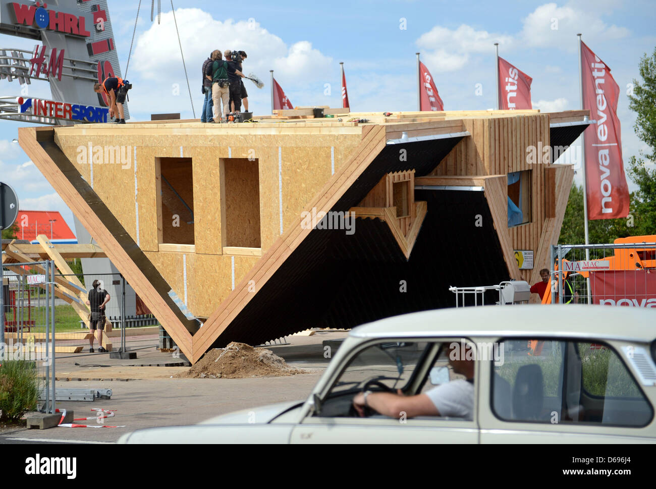 Builders Work On An Upside Down House By Manufacturer Das