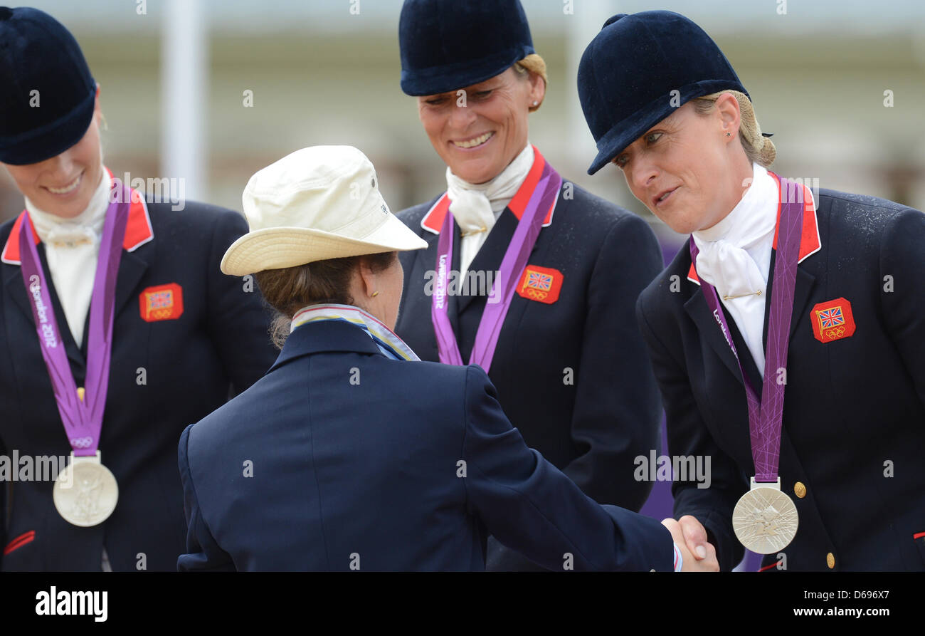 British Princess Anne (2-L) congratulates silver medalist Zara Phillips (L-R),  Mary King and Kristina Cook of the british eventing team after the  Equestrian team Eventing during the London 2012 Olympic Games in