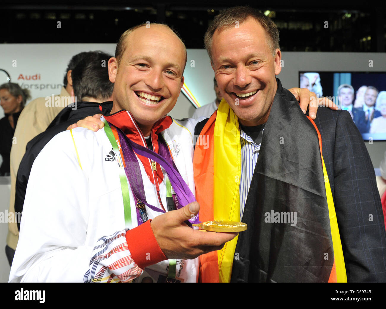 German gold eventing rider Michael Jung (L) talks to Hinrich Romeike of Germany, the eventing double gold medal winner of the 2008 Olympics in Hongkong, at the Deutsche Haus in London, Britain, 31 July 2012. Photo: Jochen Luebke dpa  +++(c) dpa - Bildfunk+++ Stock Photo