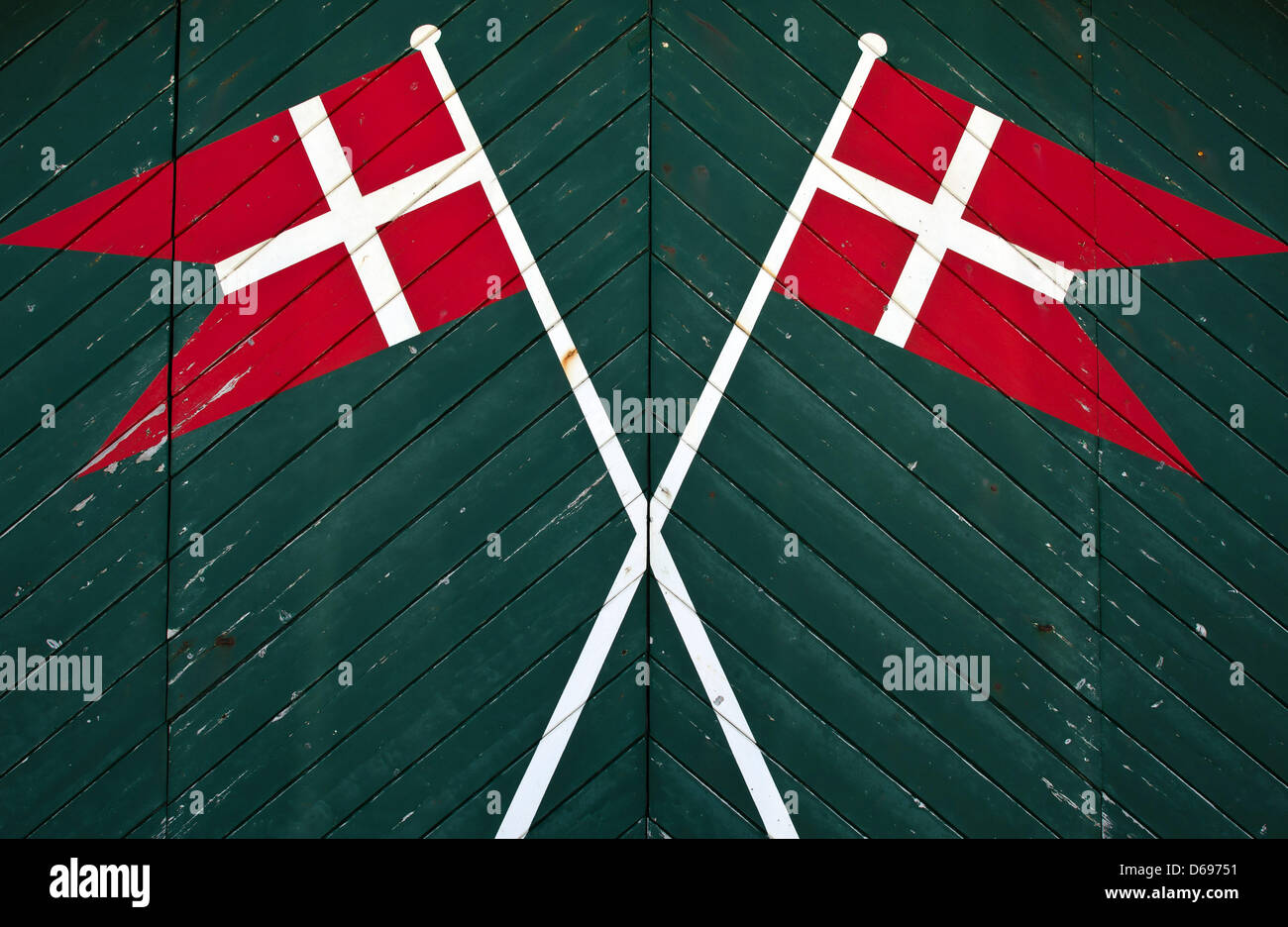 Two Danish flags have been painted on a a barn door at Denmark's west coast near Tranum, Denmark, 27 June 2012. The west coast is one of Denmark's most popular holiday regions. The coast runs from German-Danish border in North Frisia to the mouth of the Limfjord. Wide, white beaches, clear sea water, dunes, moorlands and pinewoods attract many holiday makers. Photo: Patrick Pleul Stock Photo