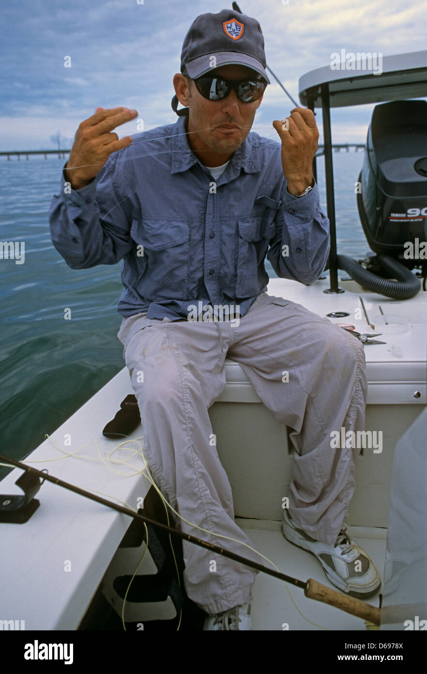 A fly fishing guide tying a leader for tarpon at Marathon in the