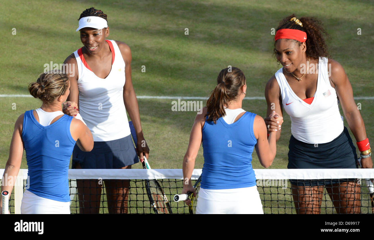 Venus (2-L) and Serena Williams (R) of the USA shake hands with Italy's  Sara Errani and Roberta Vinci (C) after their Women's Doubles quarterfinal  match during the tennis tournament of the London