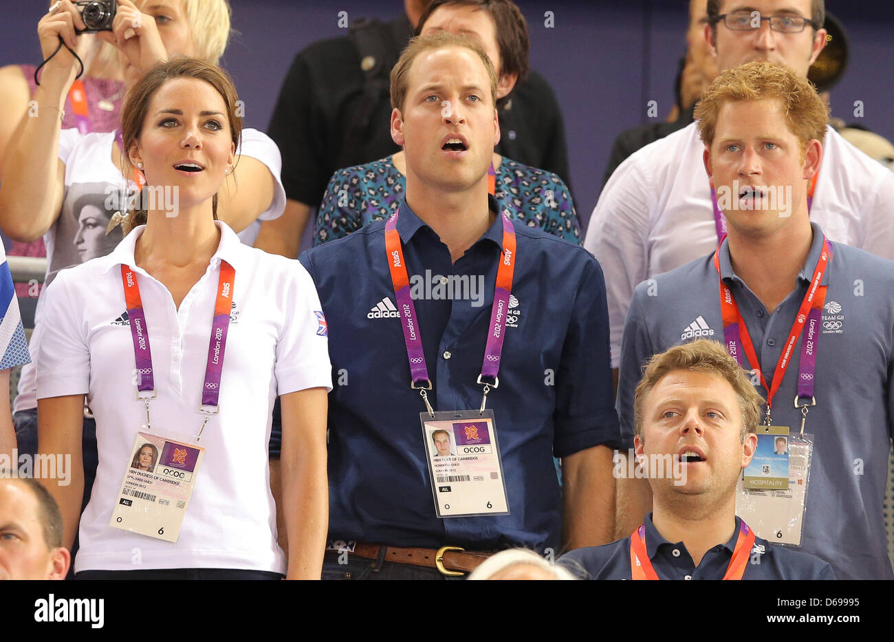 Prince William (C), Duke of Cambridge and Catherine (L), Duchess of Cambridge Prince Harry (R) sing the national anthem after Great Britain wons the men's team sprint in Velodrom at the London 2012 Olympic Games, London, Great Britain, 02 August 2012. Photo: Christian Charisius dpa Stock Photo