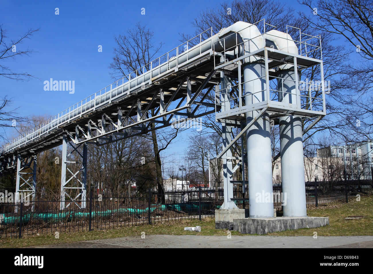Industrial pipelines on pipe-bridge against blue sky Stock Photo