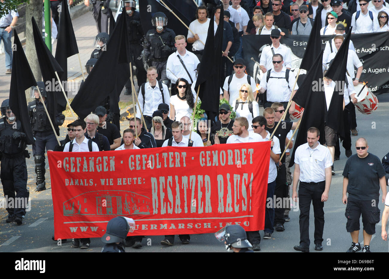 Several hundred neoNazis carry banners and flags during a socalled