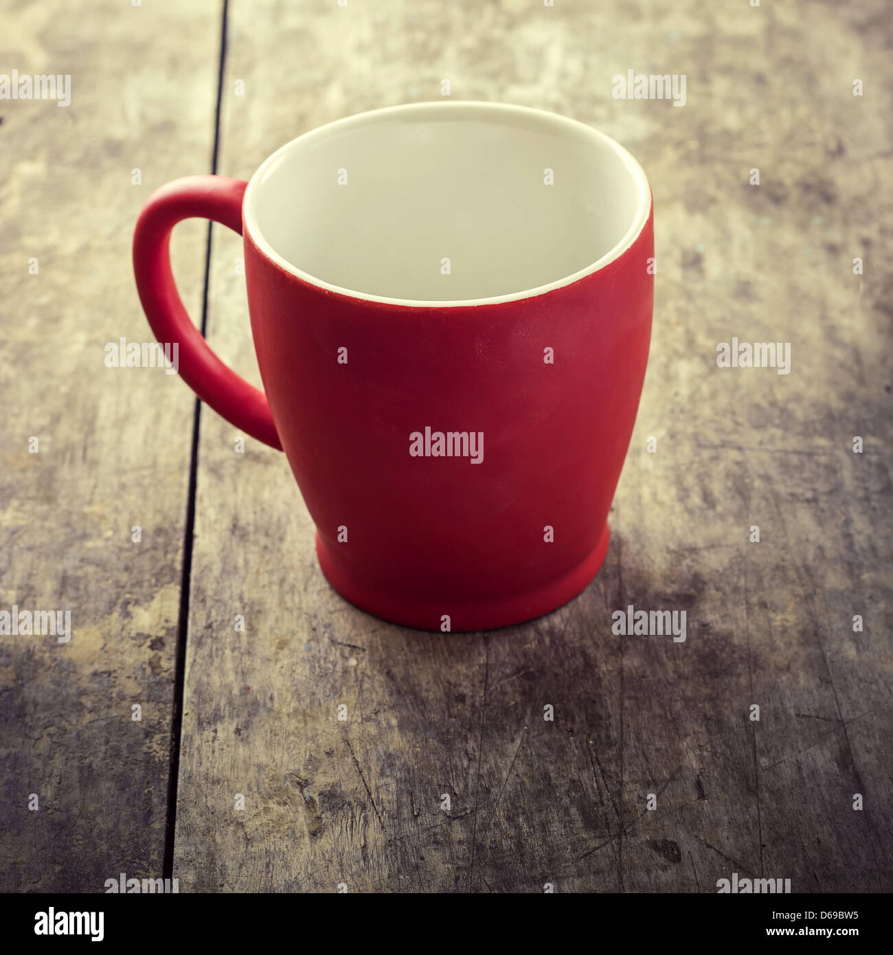 empty old red coffee mug on old wooden table,retro Stock Photo