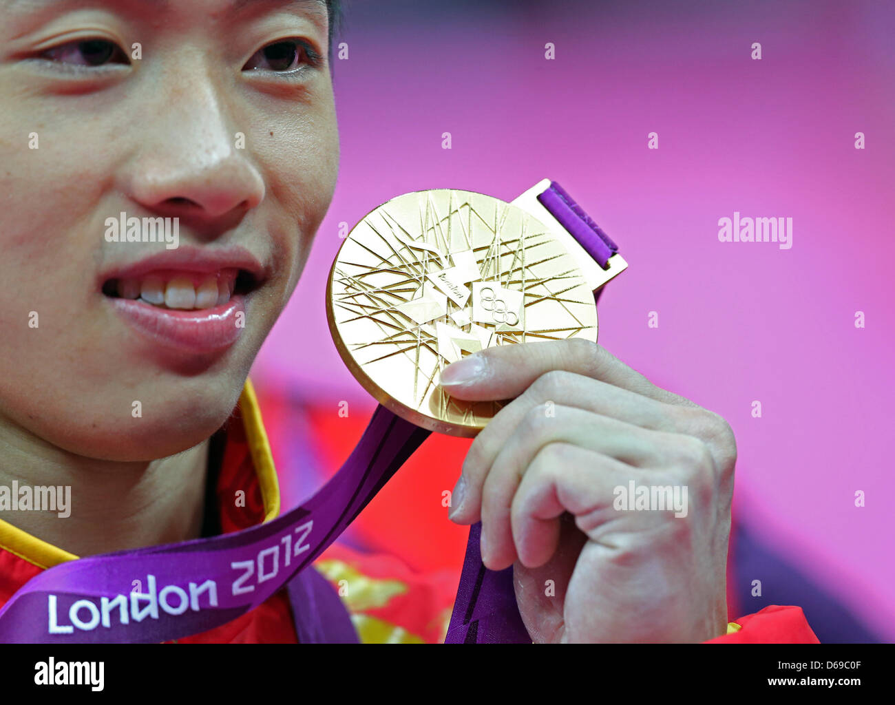 Kai Zou of China celebrates his gold medal during the medal ceremony ...
