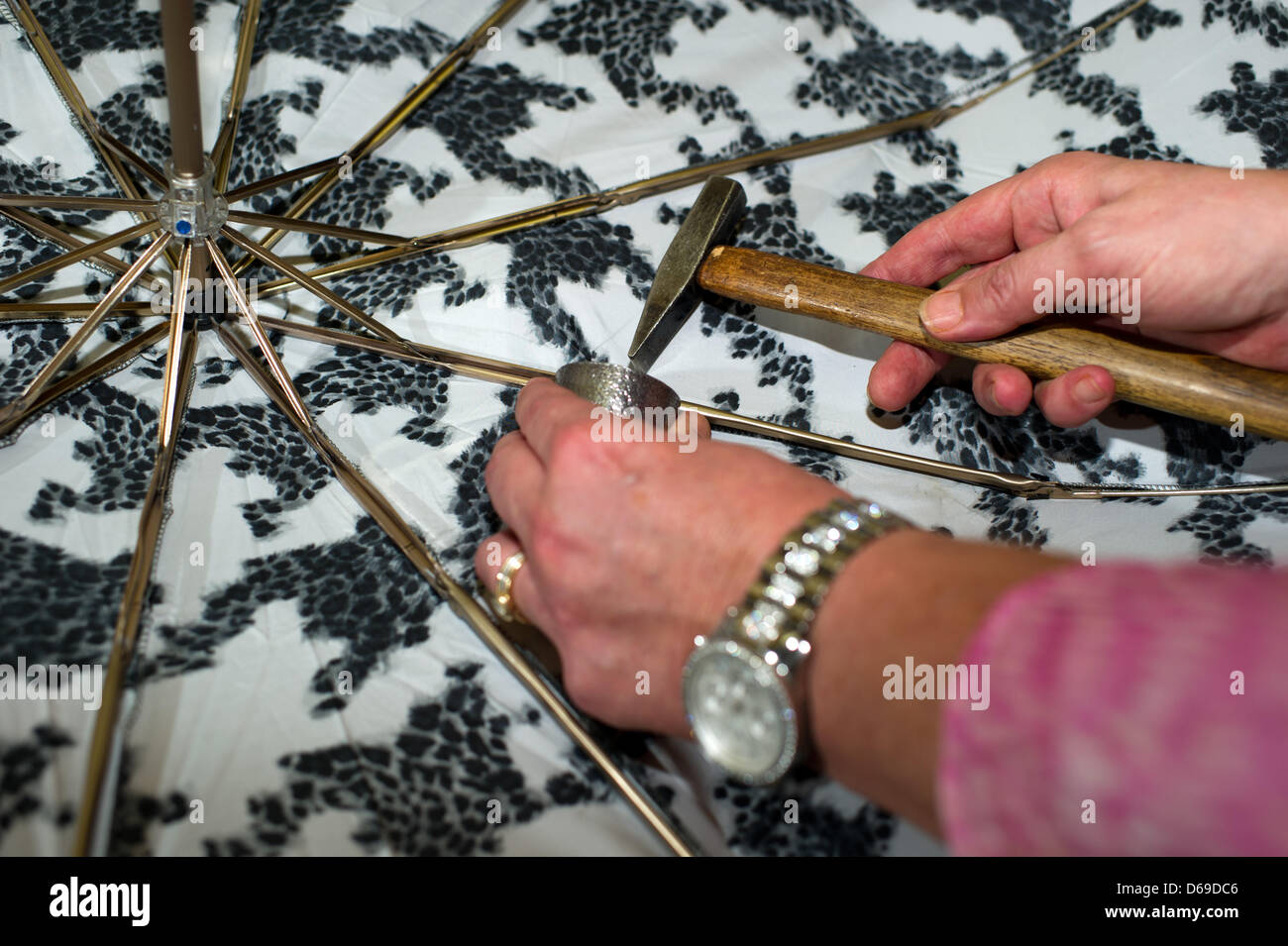 Umbrella maker Jacqueline Brueckner at work inside her shop in Berlin