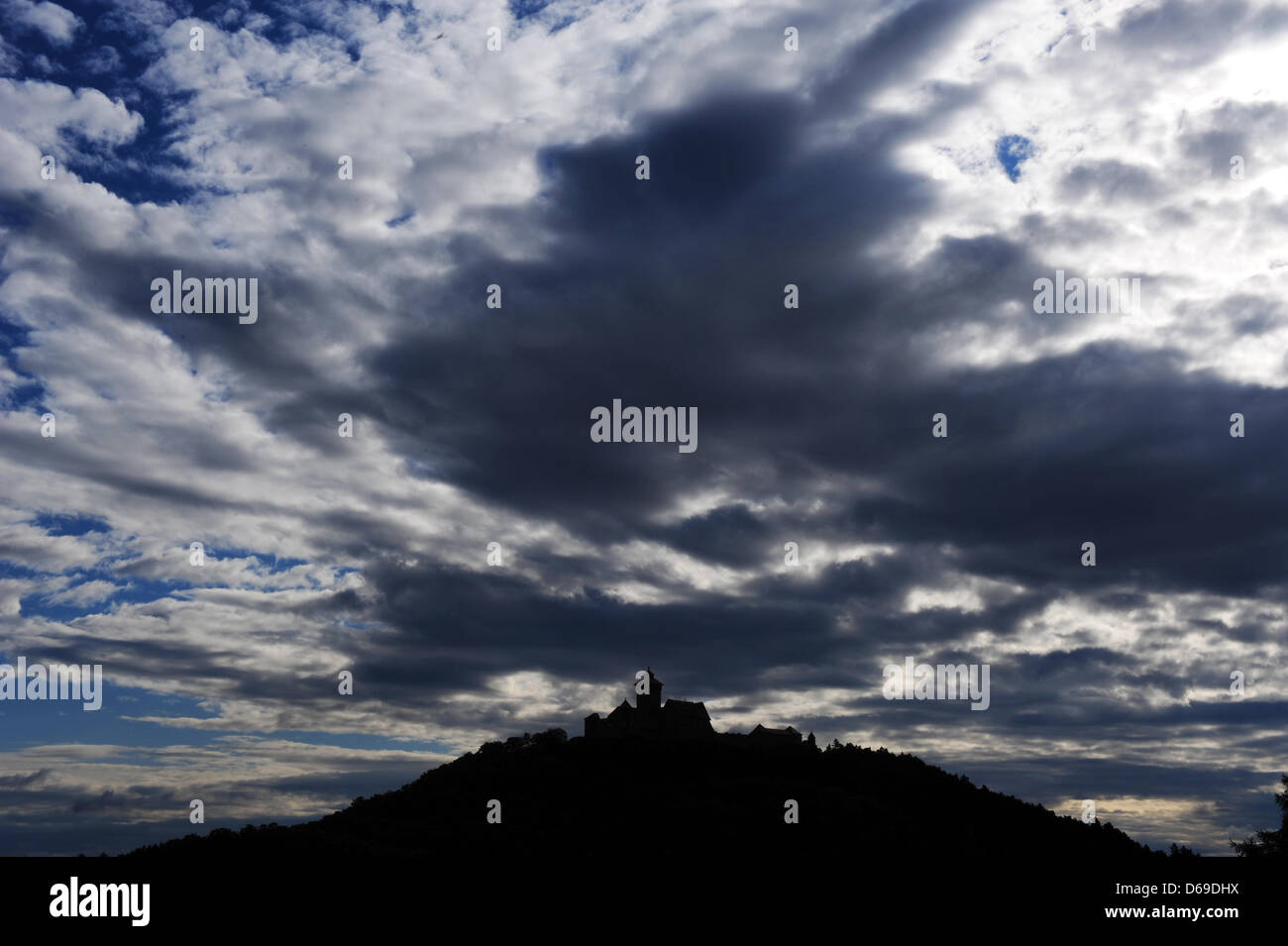Clouds move across the Wachsenburg castle near Holzhausen, Germany, 07 August 2012. Meteorologists predict changable weather for the coming days. Photo: Martin Schutt Stock Photo