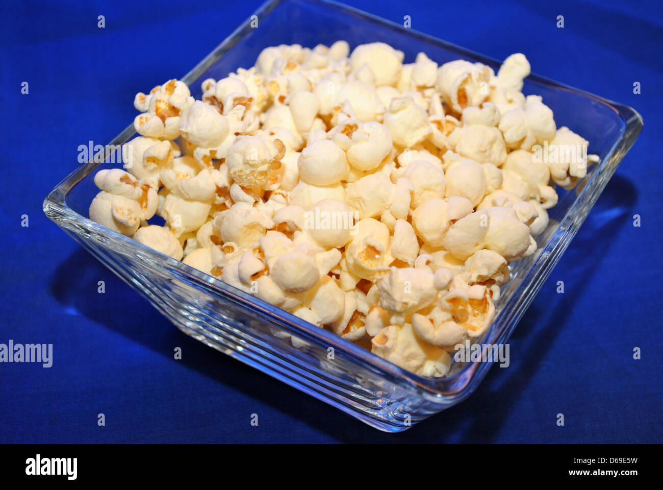 Glass Bowl with Healthy Popcorn Over Blue Stock Photo Alamy