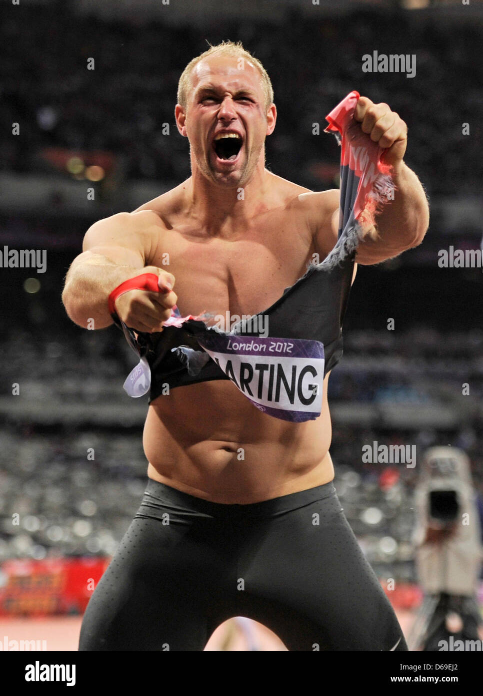 Robert Harting of Germany celebrates after winning the Men's Discus
