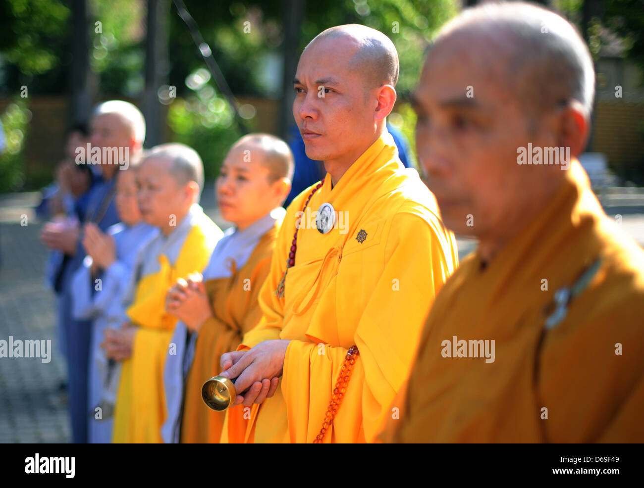 Buddhist monks stand in front of the Buddhist monastery 'Pagode Vien ...