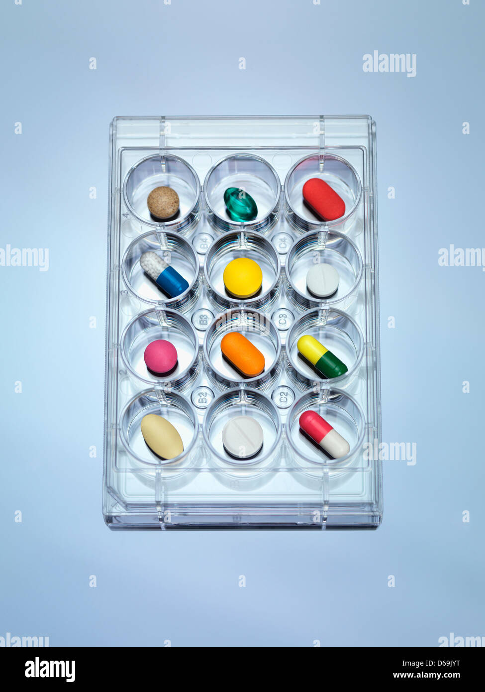 A variety of drugs sitting in a multi well sample tray Illustrating