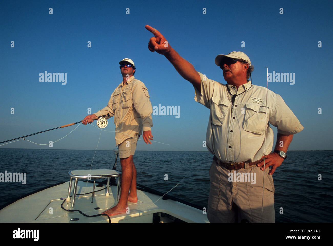 Fly fishing guide points out fish to client at Port O'Connor Texas